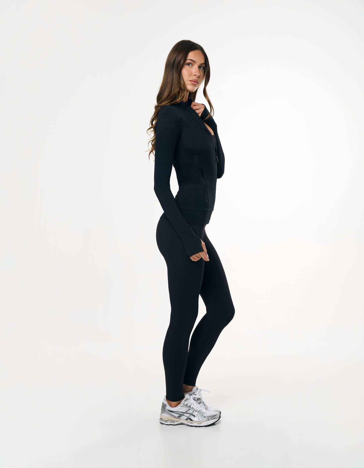 Side profile of STAX. Zip Jacket NANDEX™ in Black showing flattering tight fit